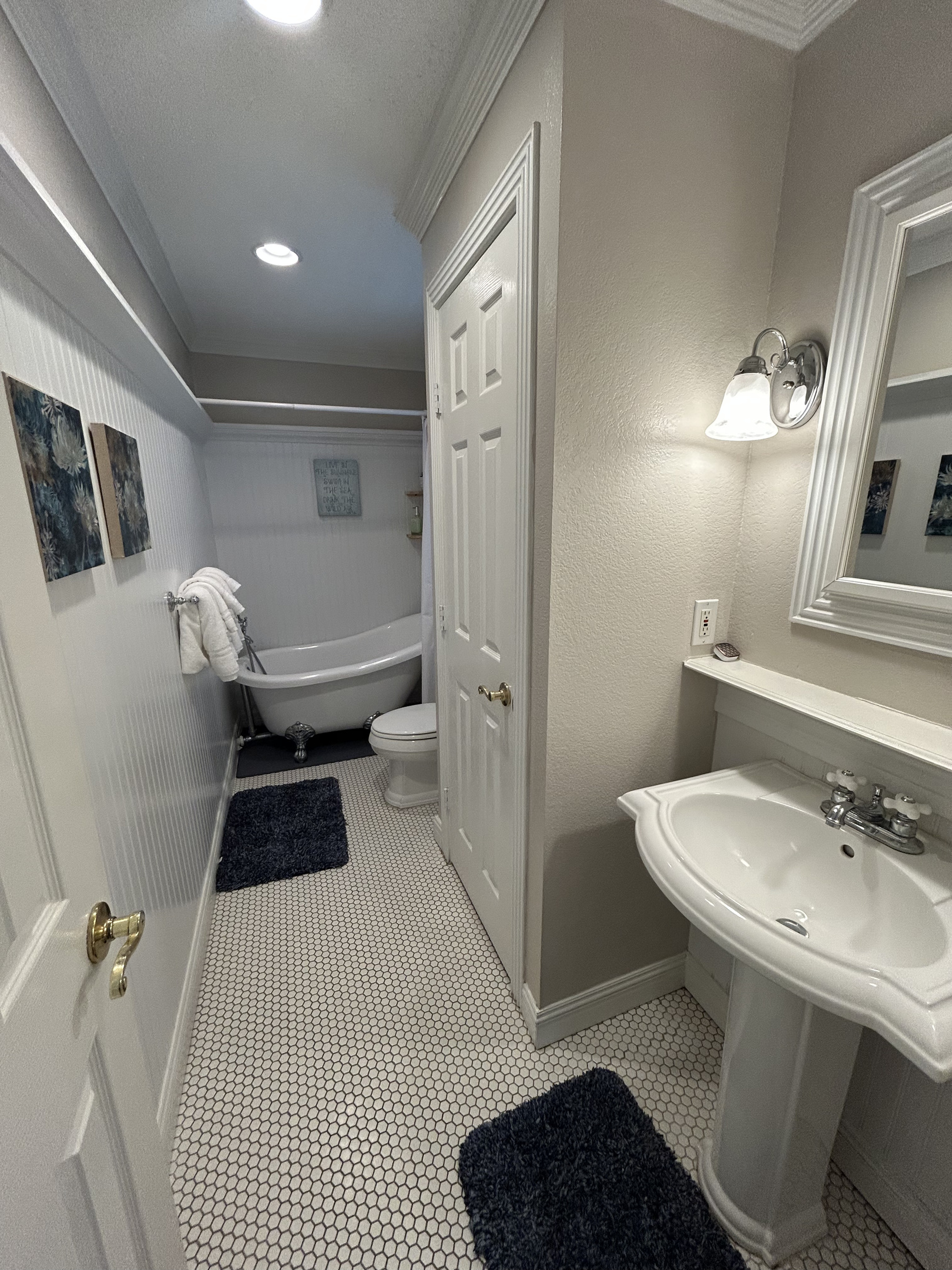 King Suite Ensuite Bathroom (Ground Level) features a classic clawfoot soaking tub and a relaxing spa-like atmosphere. The perfect place to unwind and recharge after a day at the beach, pool, or exploring South Padre Island.