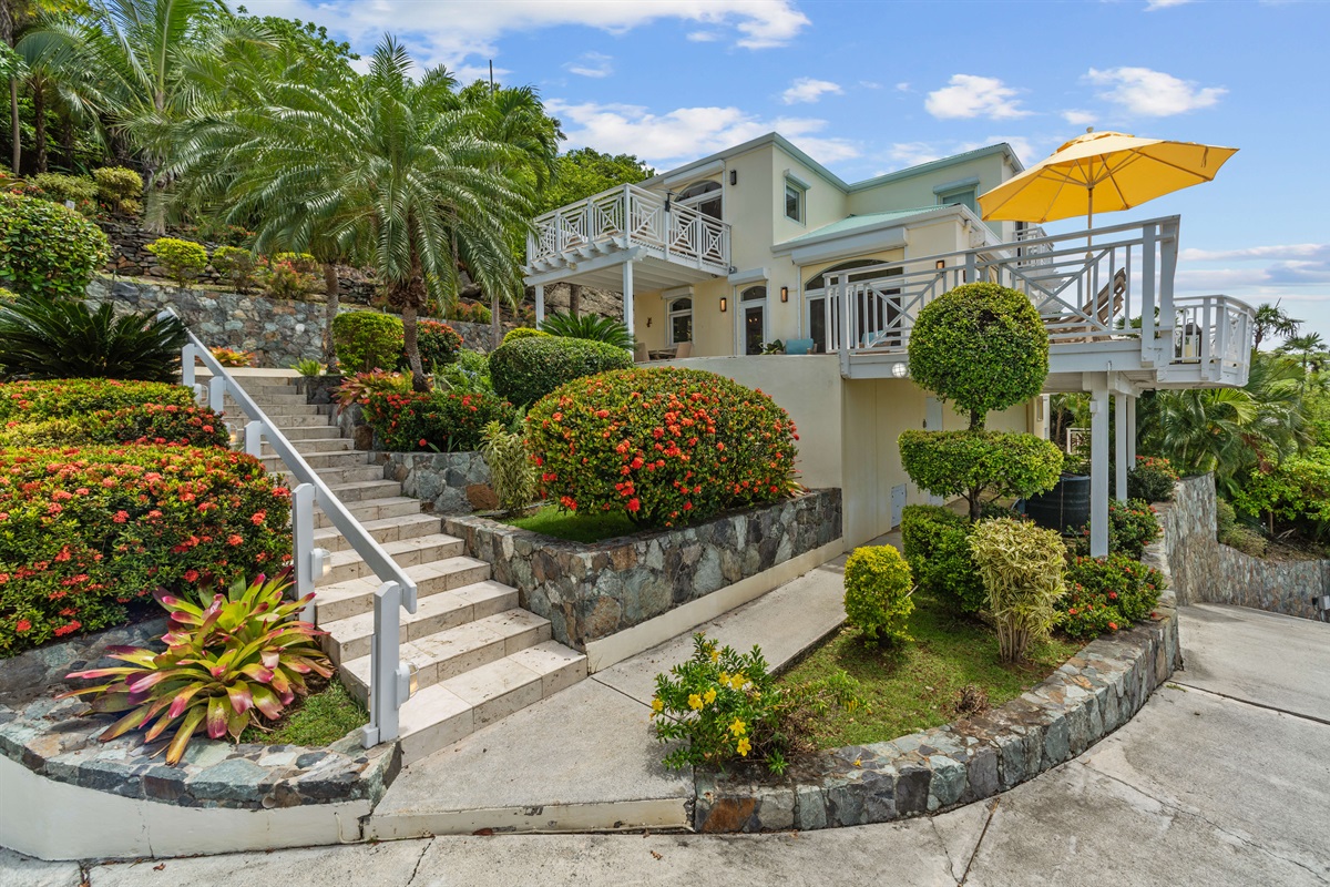 Tropical landscaping, lush plants, and walkways that make even coming home feel like a vacation.