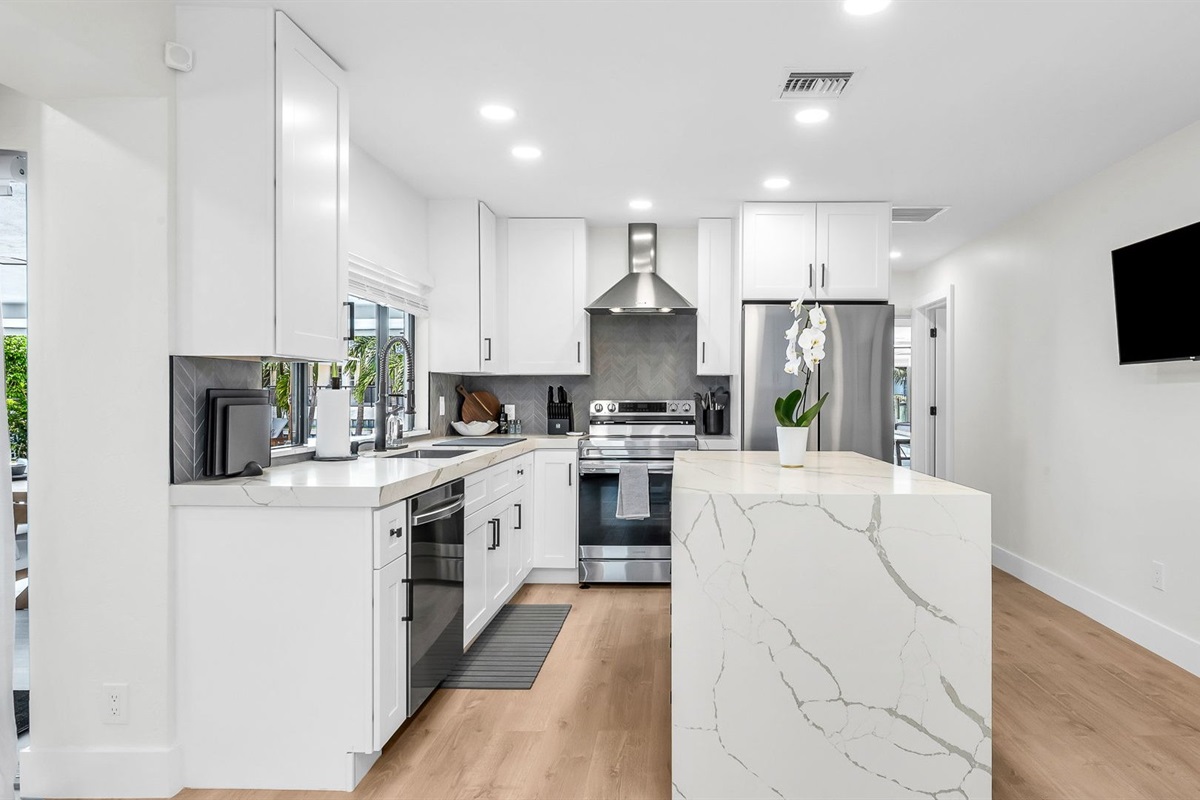 Bright and airy, this modern kitchen combines luxury finishes with everyday comfort. Enjoy the designer backsplash, expansive counter space, and seamless flow to the dining and living areas.