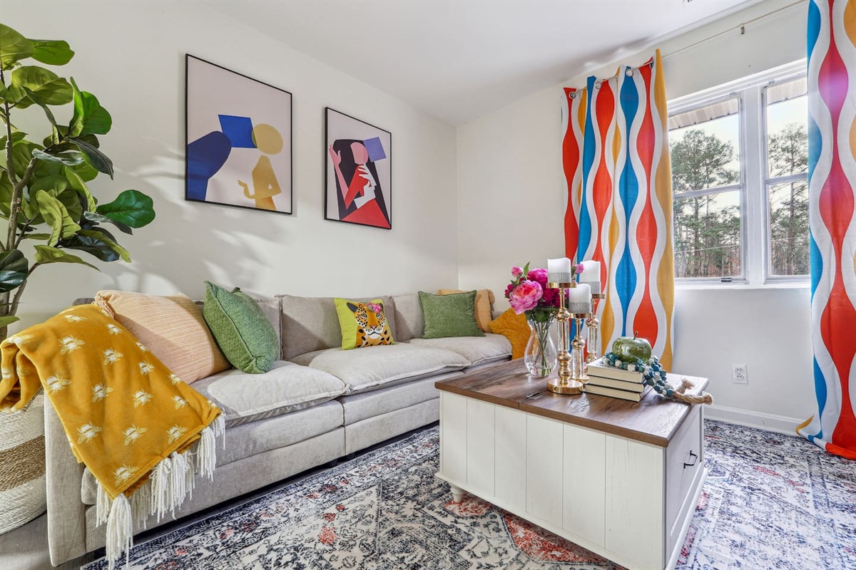 Enjoy a cozy living room featuring a comfortable couches, a TV for your entertainment, and a window with a lovely view outside, perfect for relaxing and unwinding.