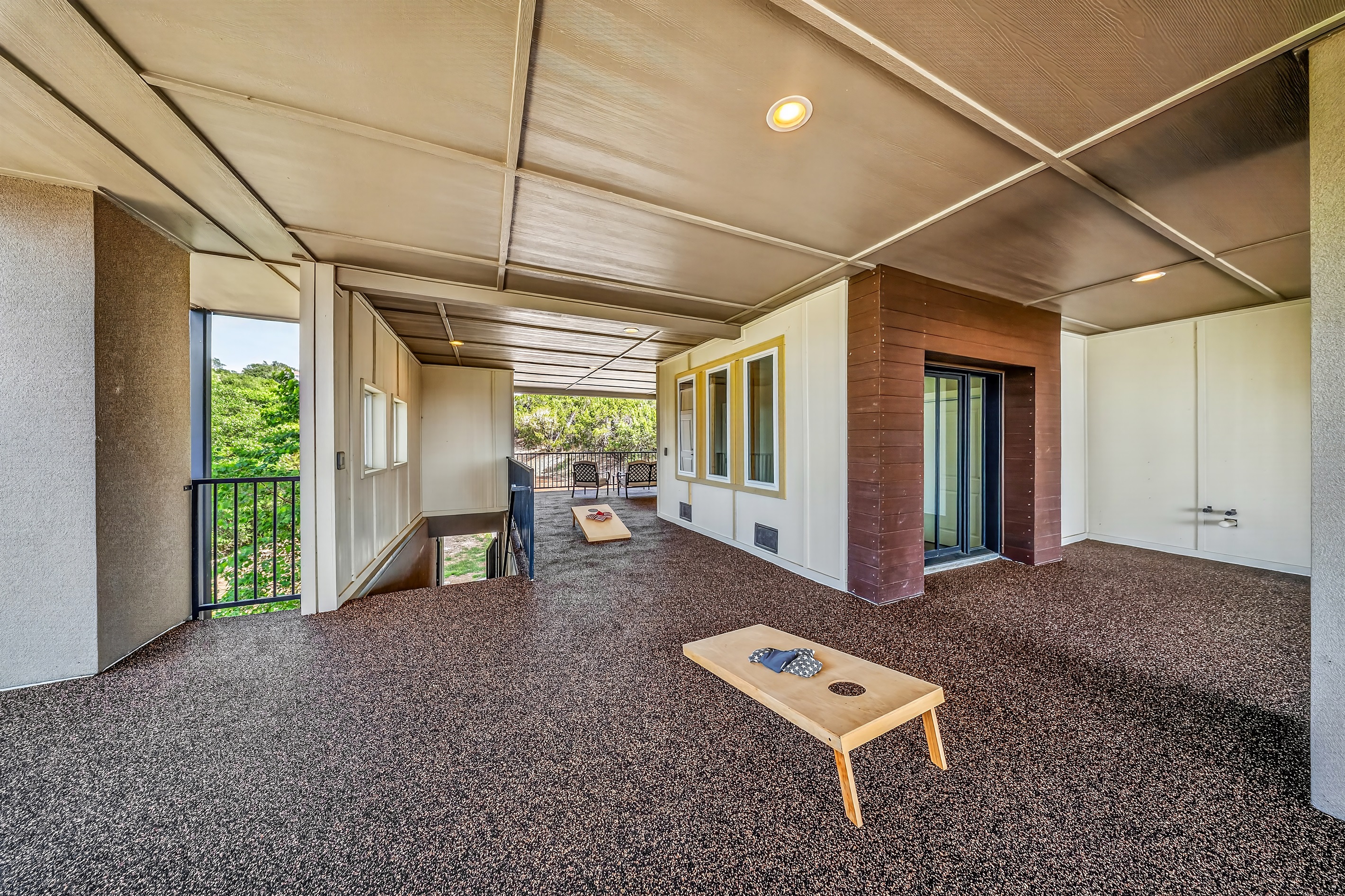 - Covered patio with open railing and shaded seating area - Easy access from stairs ensures smooth flow for guests - Spacious design perfect for lake hangouts and relaxing moments