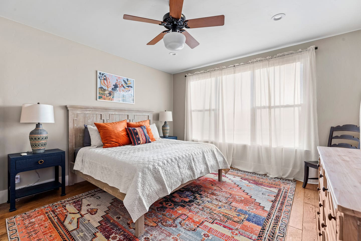 Master bedroom features a king bed, TV and attached ensuite full bathroom, clawfoot soaking tub, walk-in shower