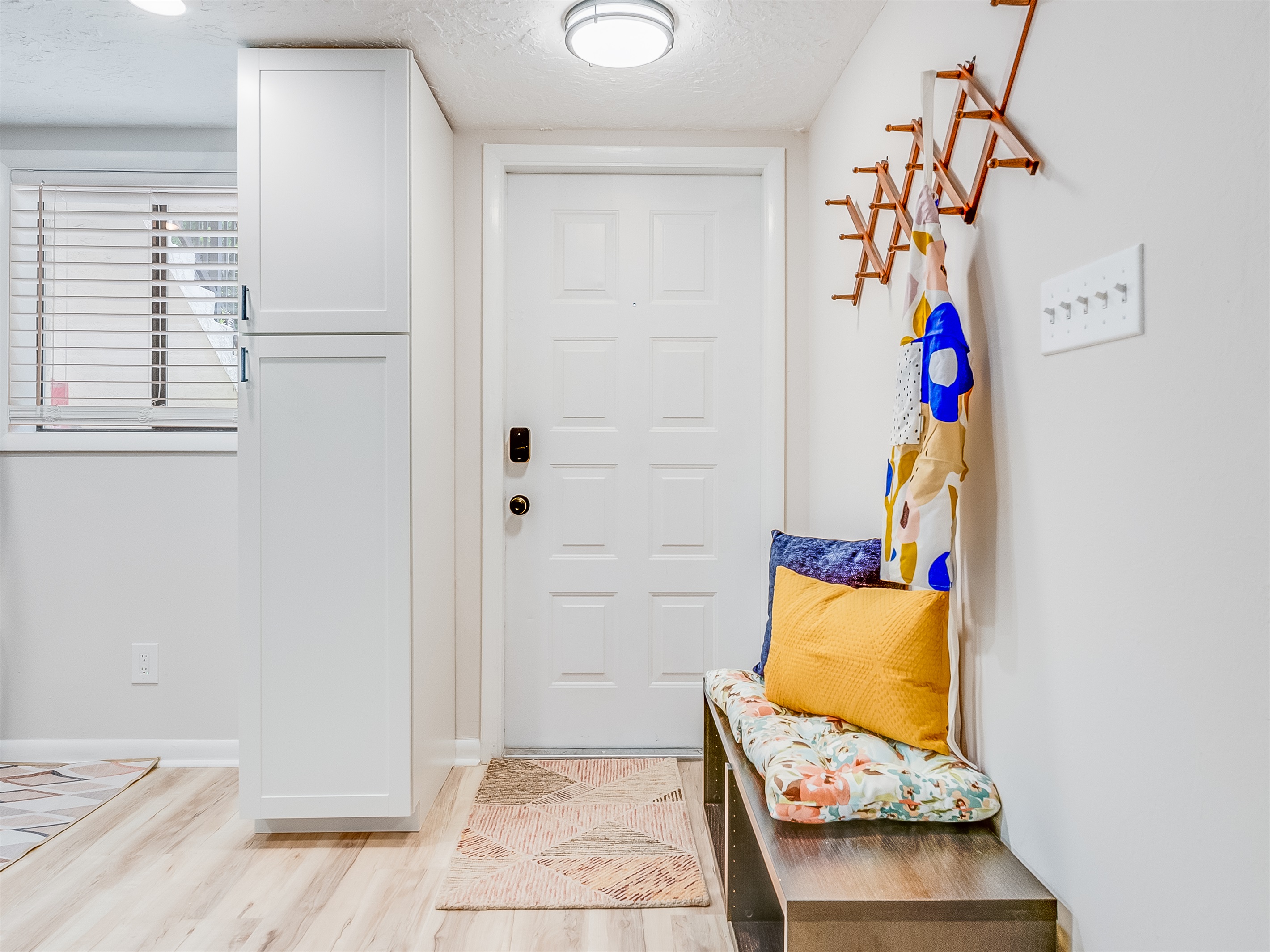 A convenient bench near the entrance is perfect for slipping off shoes and settling in.
