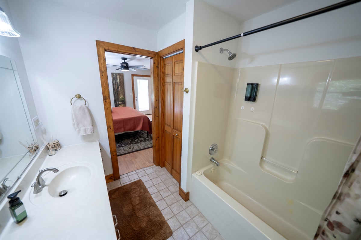 Clean and comfortable shower/tub combo for both convenience and relaxation.