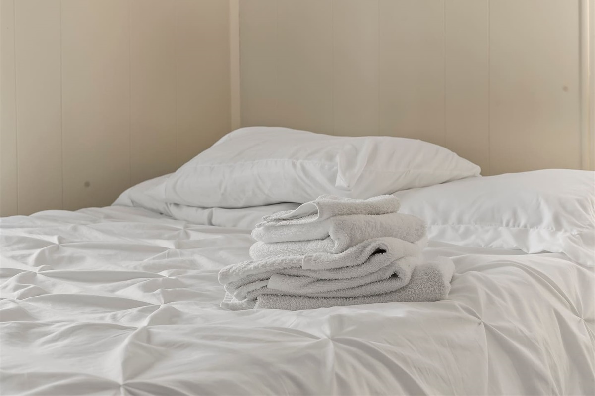 Bedroom two offers comfort and convenience with storage and natural light.