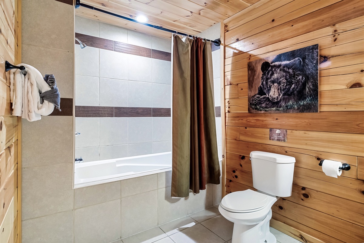 Slow things down in a serene bathroom where a relaxing tub and warm cabin finishes invite a deep exhale.