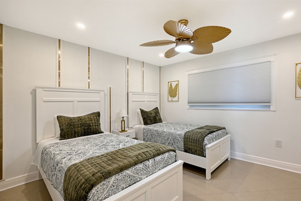 Guest bedroom with XL Twin beds & 55 " TV on dresser