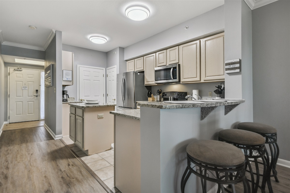 Kitchen looking into hall at front door. Breakfast bar.