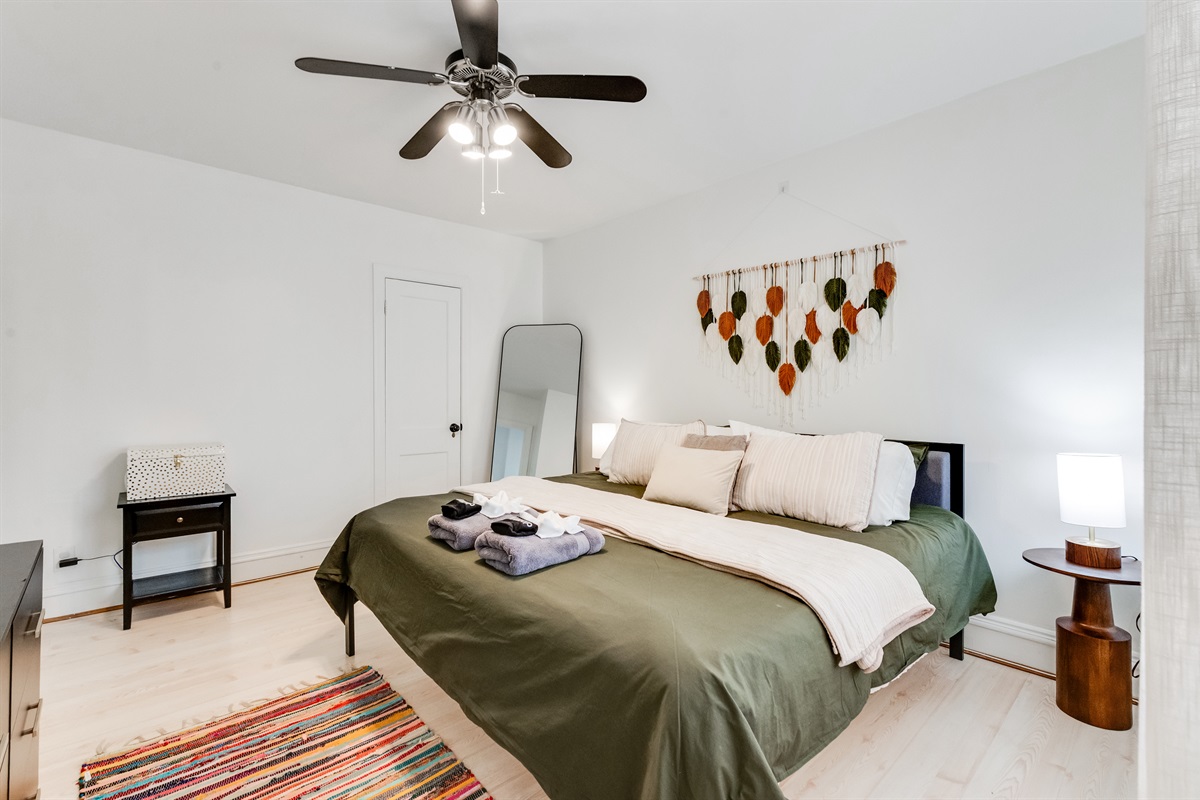 King Bedroom 1: Elegant retreat with a stylish bed and vibrant decor for a memorable stay!