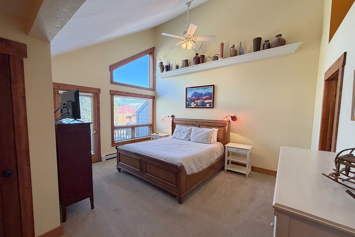 Large primary bedroom with King bed, attached full bathroom and private balcony.