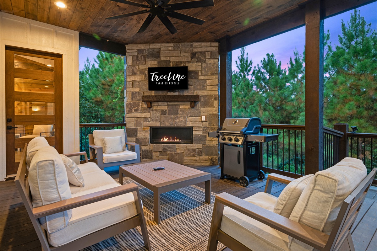 Another angle of the outdoor lounge, complete with grill and fireplace.