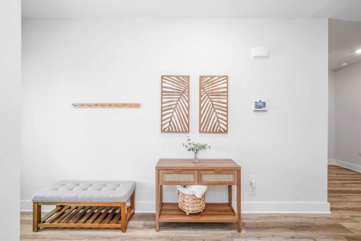 Bright and welcoming entryway featuring a cozy bench for changing shoes and stylish decor