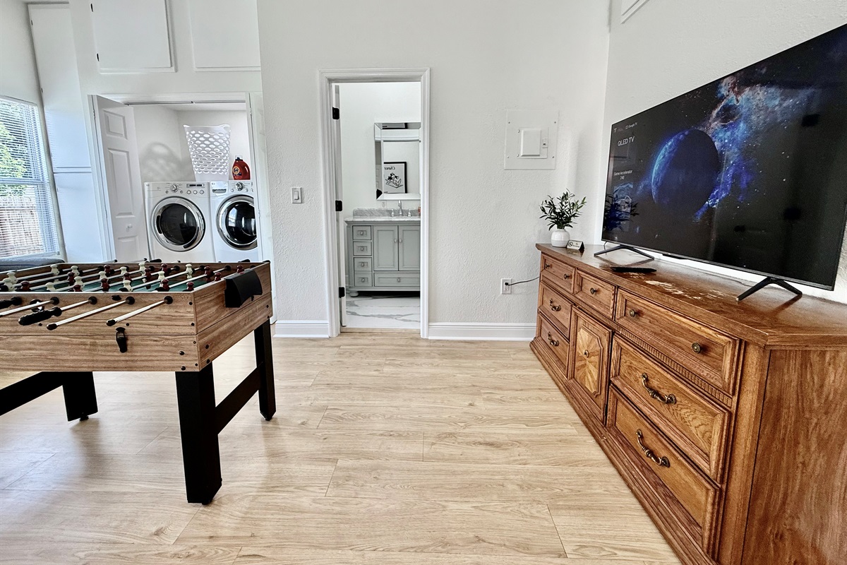 Take a break from the Florida sun with a foosball showdown, or toss in a quick load of beachwear—this room blends comfort, function, and fun all in one cozy corner.