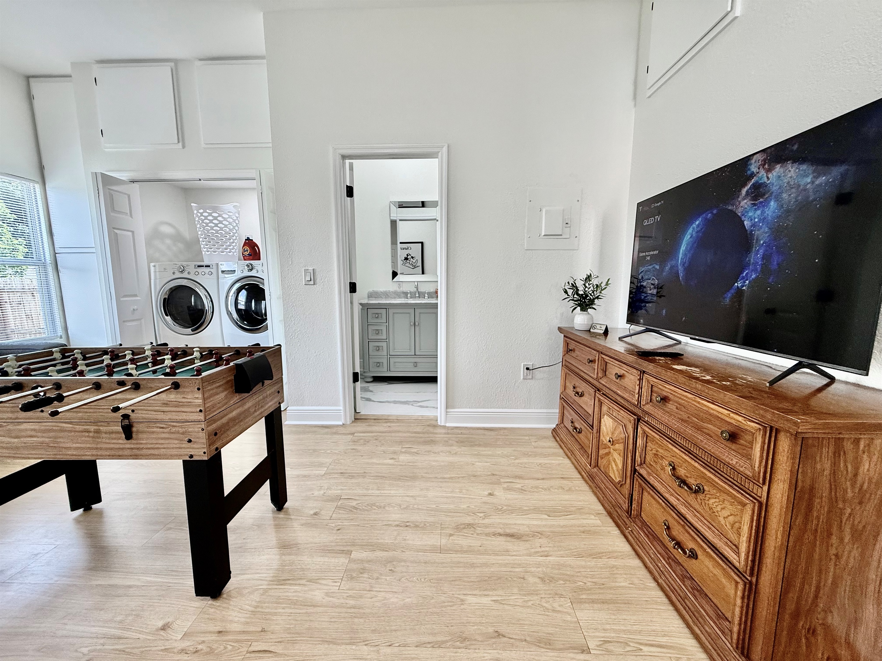 Take a break from the Florida sun with a foosball showdown, or toss in a quick load of beachwear—this room blends comfort, function, and fun all in one cozy corner.