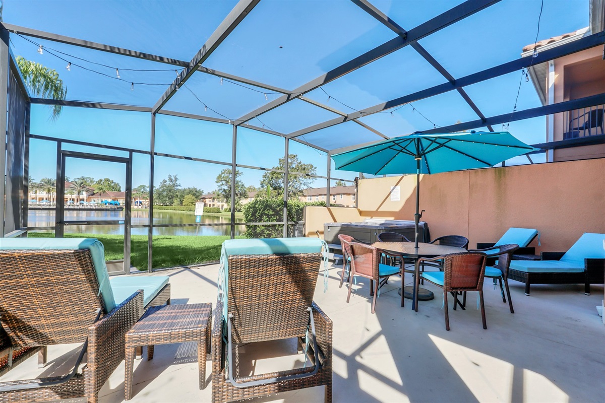 Private covered lanai with lounge area, dining area and hot tub