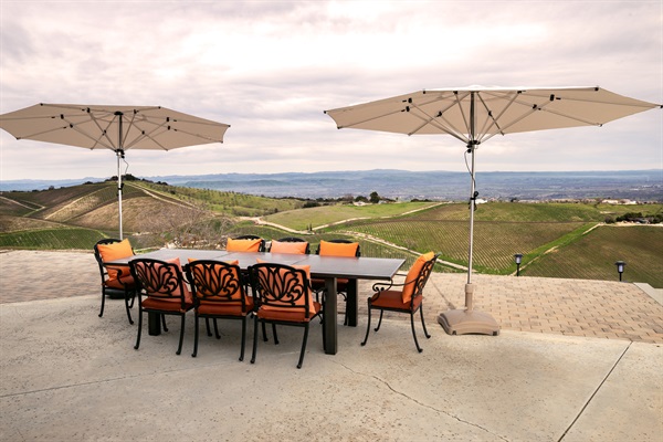Ten seats, two umbrellas, and an uninterrupted panorama of the Adelaida wine country. The outdoor dining table was made for long lunches that turn into long evenings.
