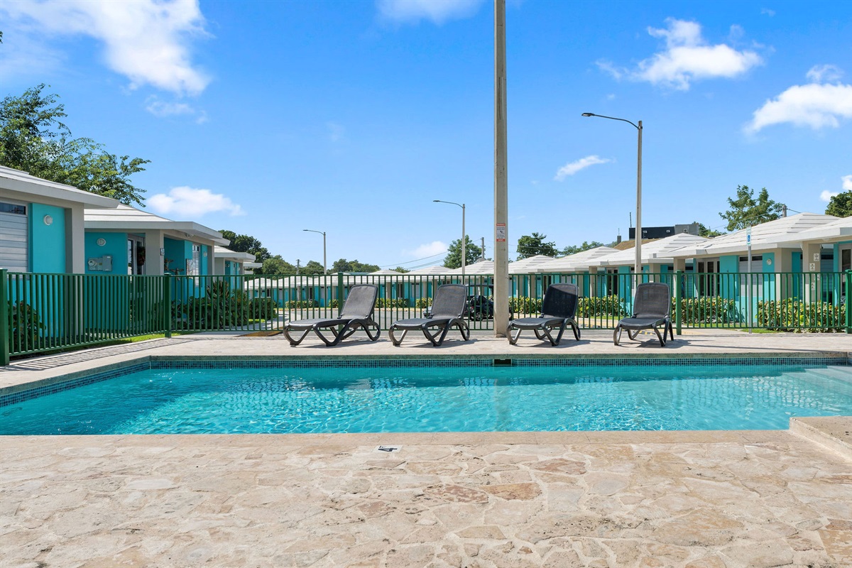 Poolside Retreat: Dive into relaxation with sun loungers just steps from the crystal-clear water!