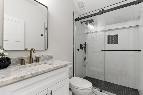 Full bathroom on the main level with walk-in shower and bidet.
