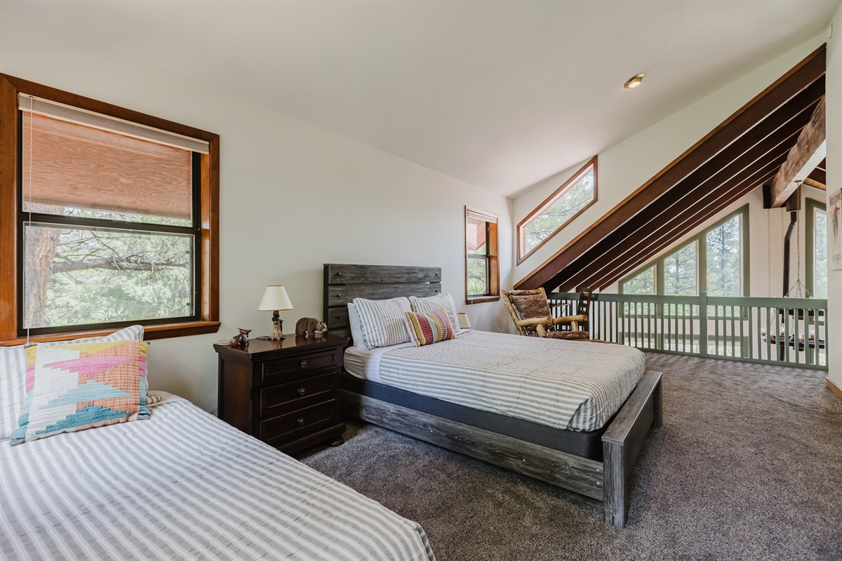 Bright loft with twin and full beds, private balcony, and stunning mountain views.