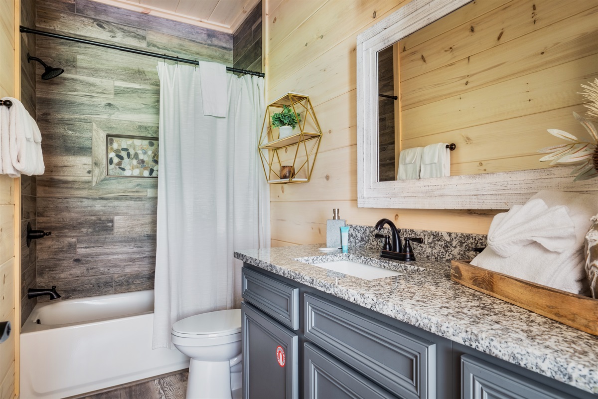 First en suite bathroom with tub and shower combo