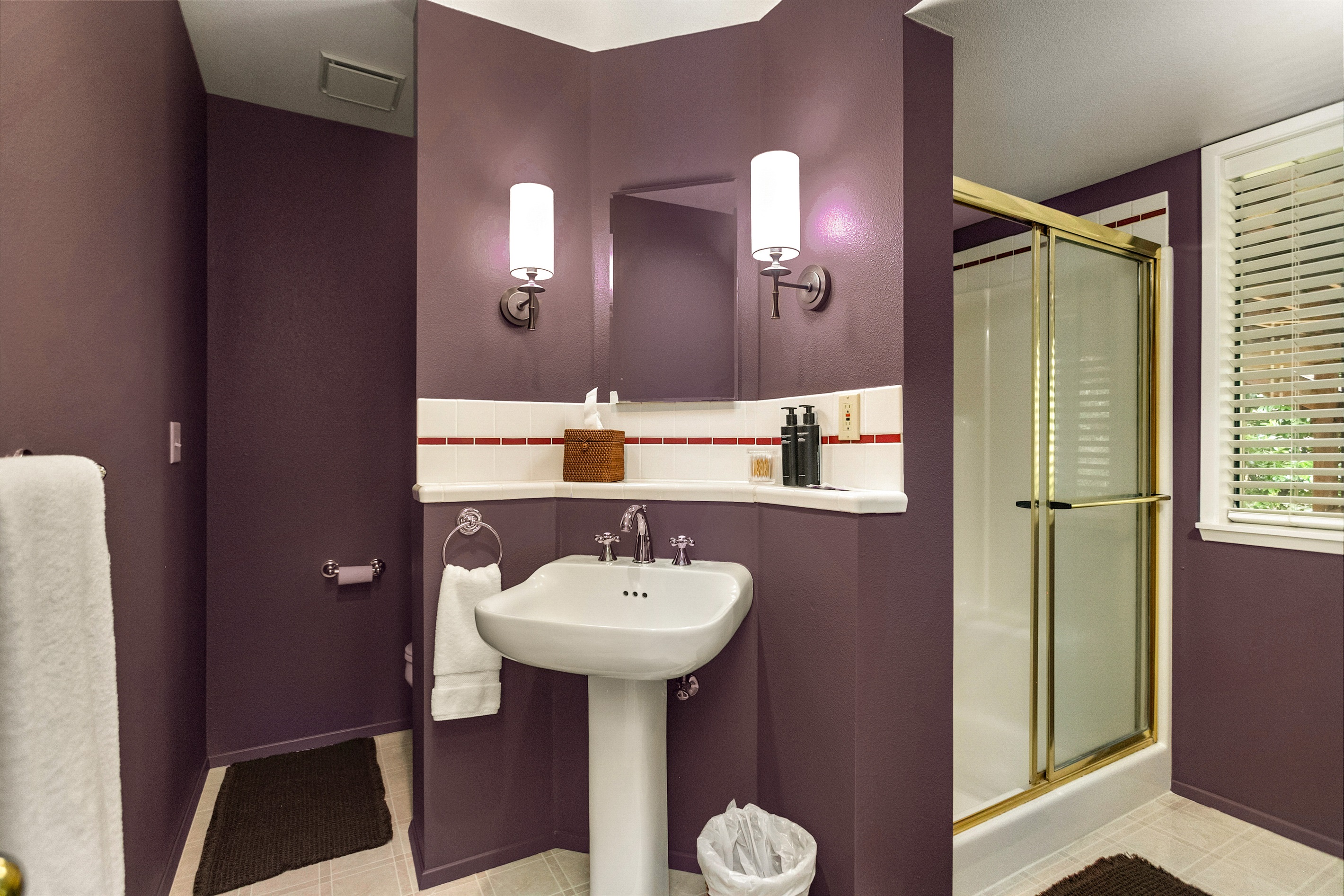 Rich color drenched ensuite bathroom attached to the massive lower bedroom.