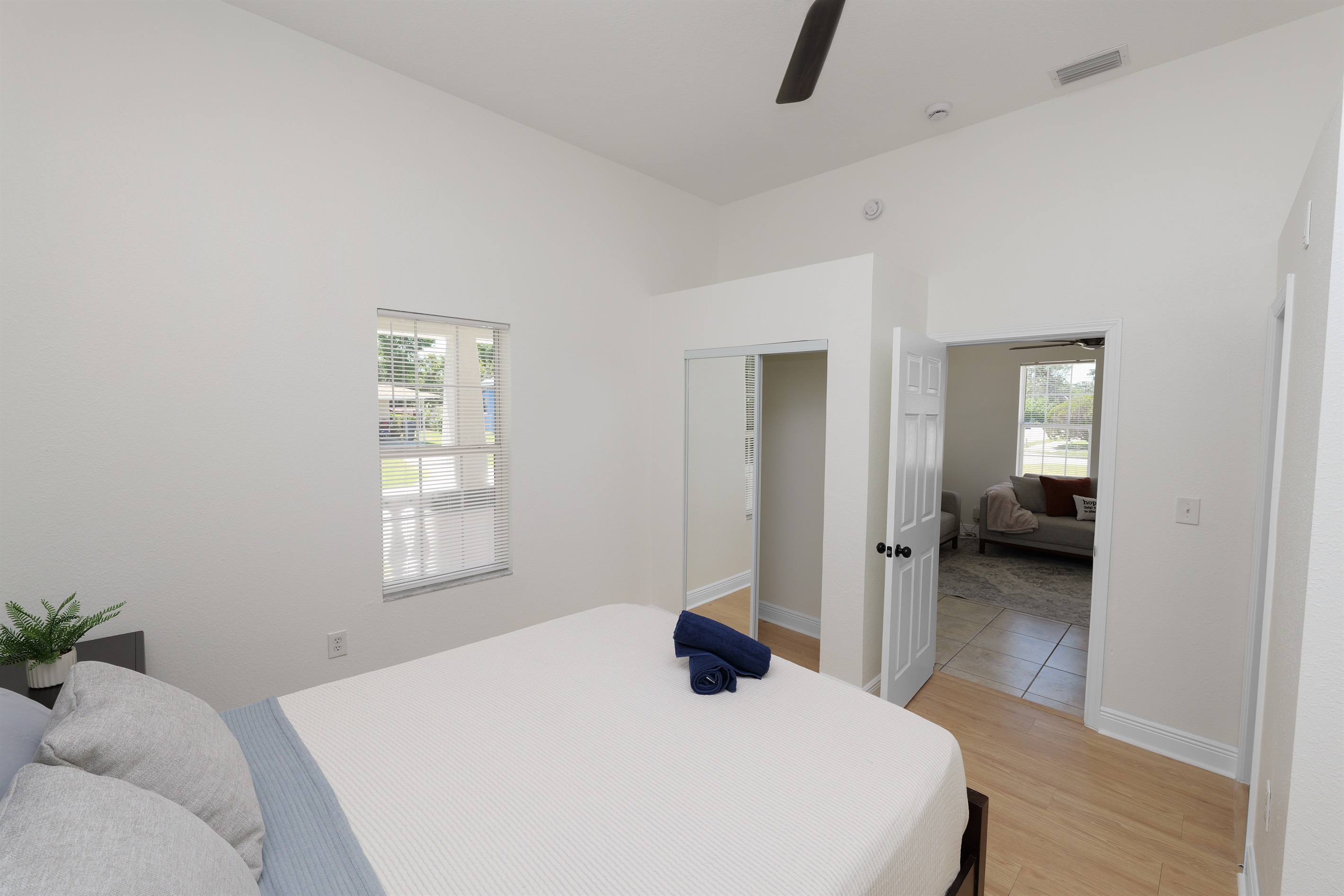 Drift off in a plush queen bed wrapped in crisp white linens, with soft pillows and a peaceful ambiance all around.