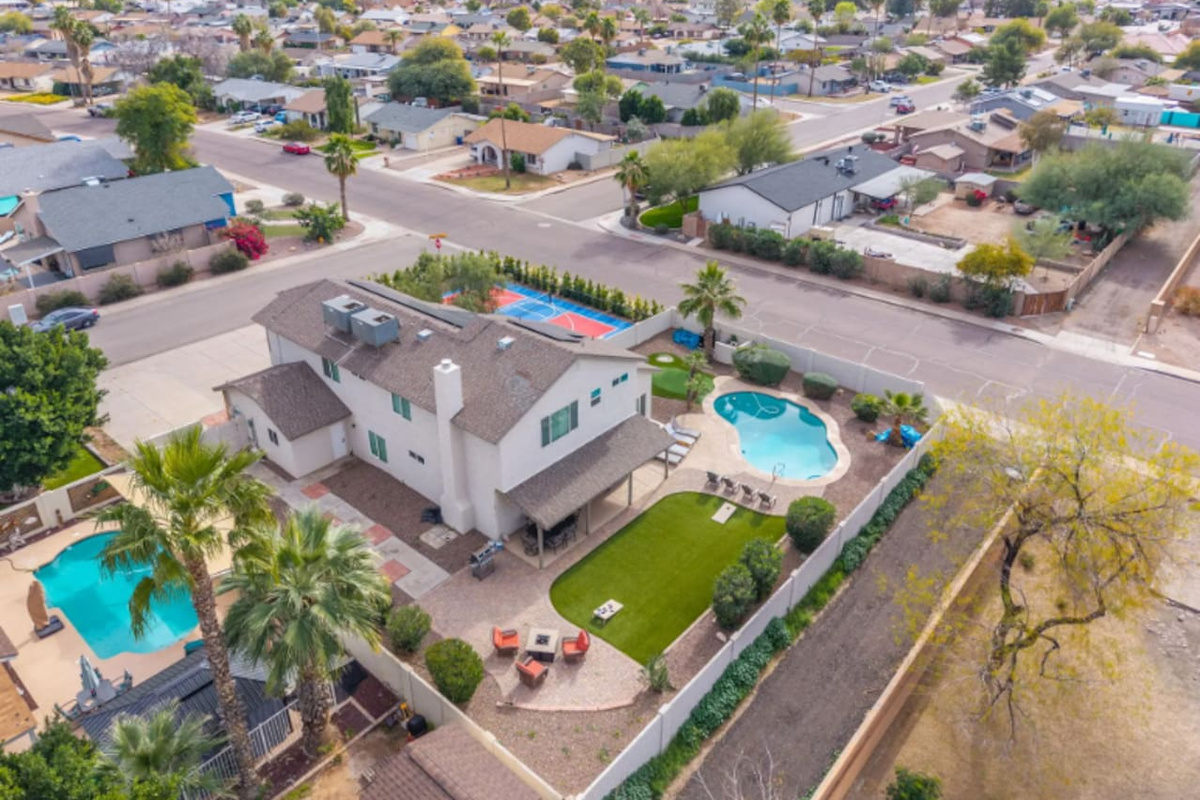 Modern home with resort pool, sports court, and sleek contemporary design in prime neighborhood location.