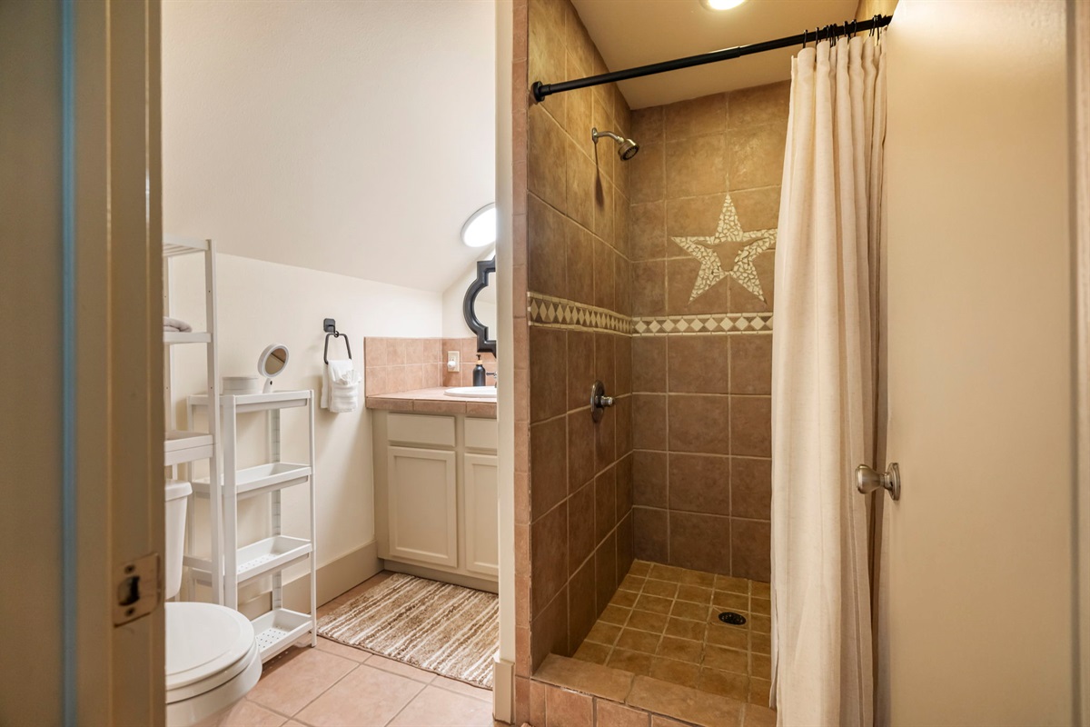 A full bathroom offers a single sink, shower, and toilet, providing everything needed for a self-contained stay.
