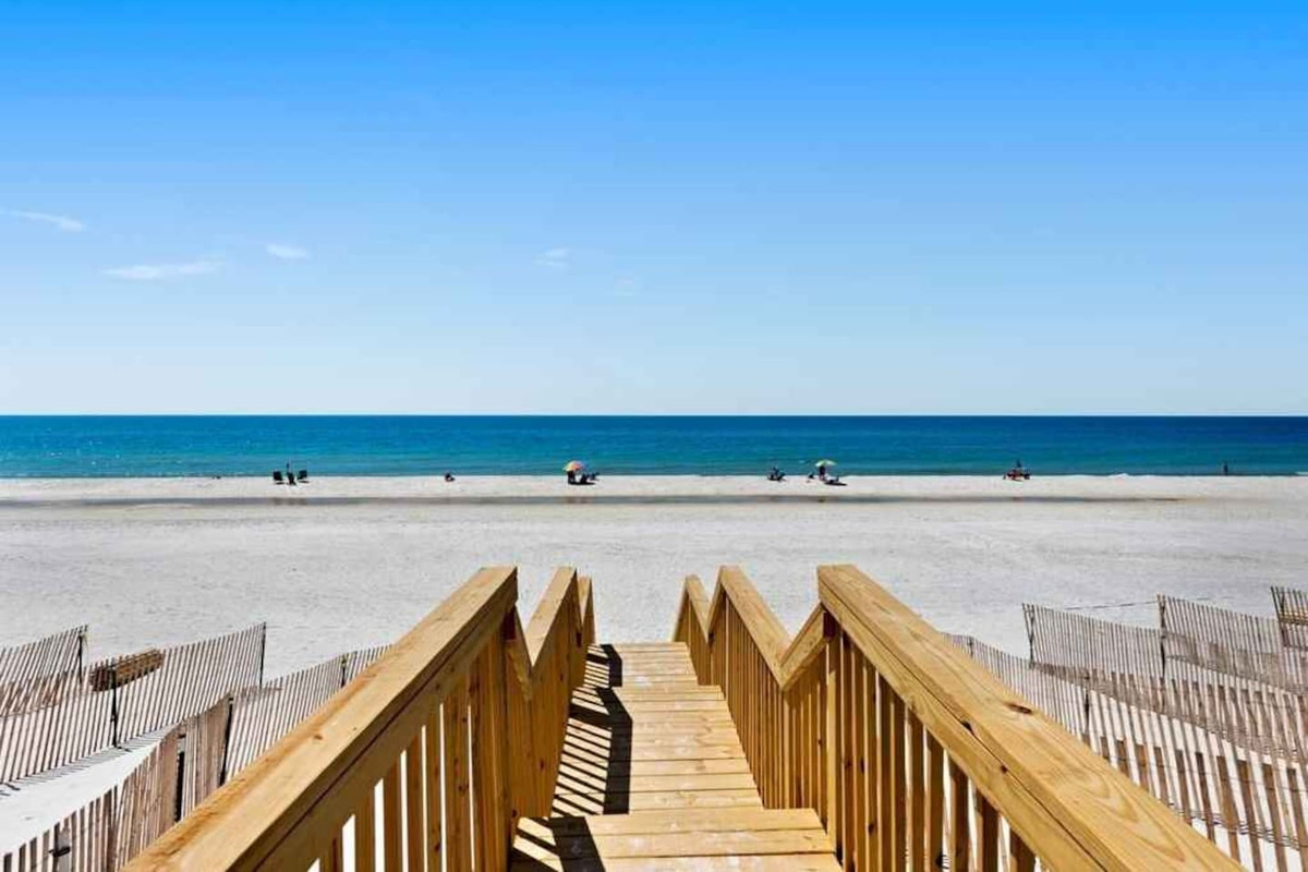 Your beach is 75 steps away &mdash; count them down the stone walkway from the back deck and you're barefoot in the sand.