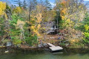 View from Long Pond of the lake house in Maine fall foliage colors