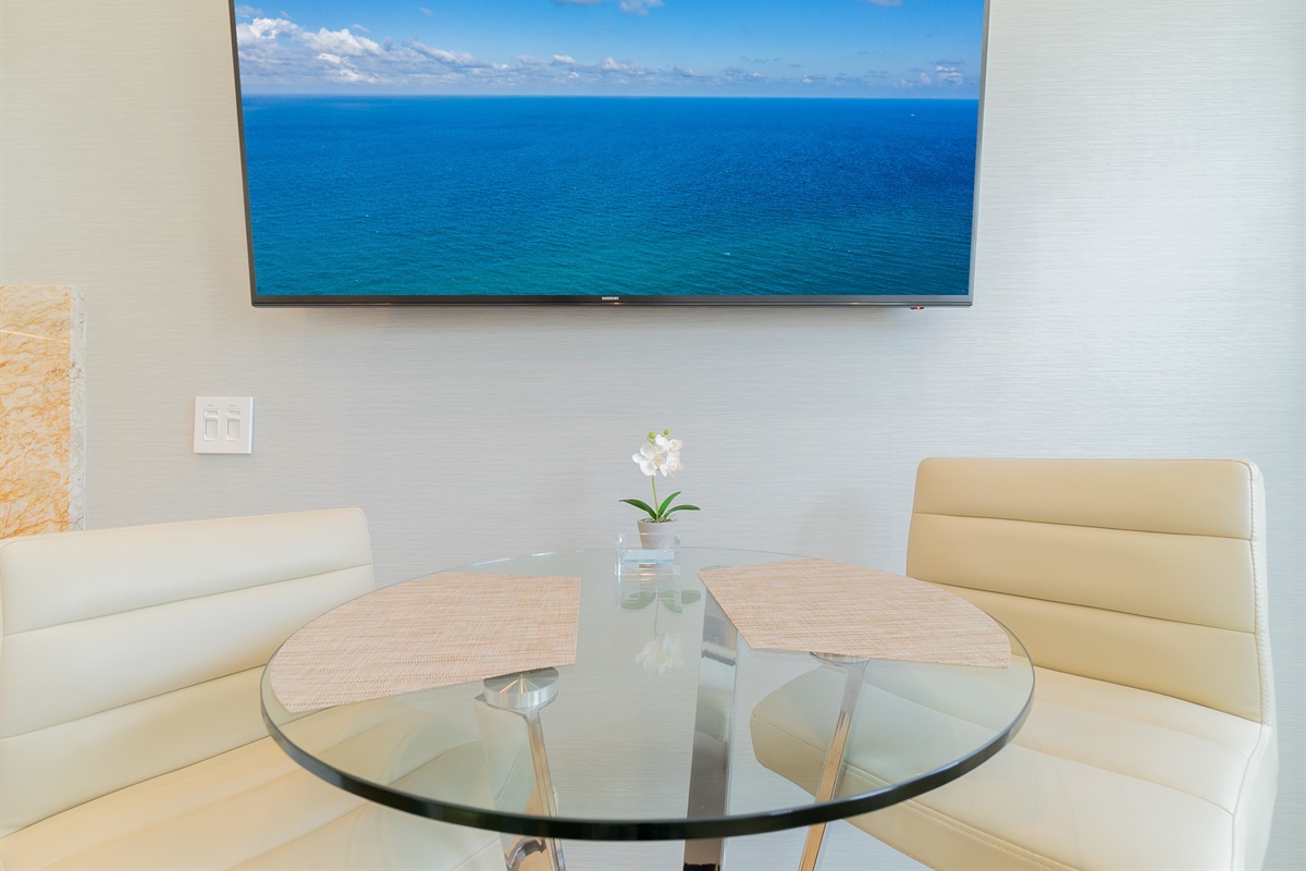 Glass dining table can also be used to work on computer. Large HD smart tv for your enjoyment