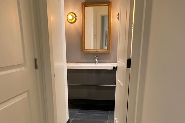 Short hallway that leads to bathroom and the laundry and dryer