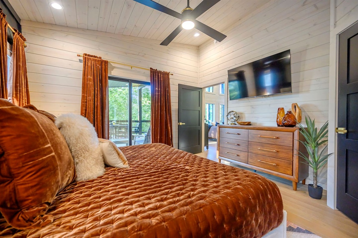 King bedroom features plush bedding, blackout drapes and a 55" TV.  Step directly onto the upper balcony to enjoy early morning coffees and the late evening sunsets.
