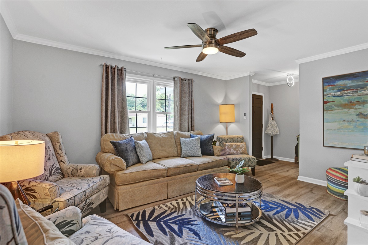 Stretch out and unwind—this spacious living room offers plush seating, warm lighting, and all the comforts of home.