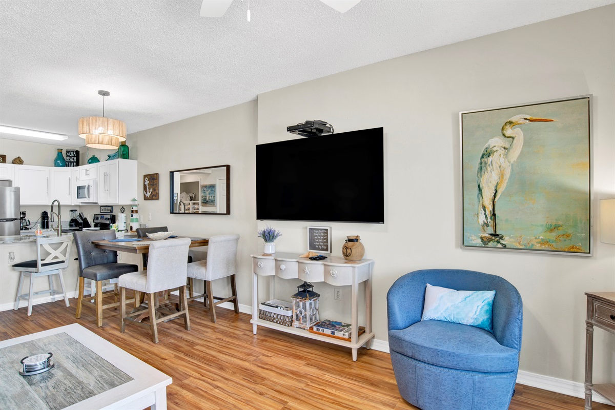 Living room with sleeper sofa, recliner, arm chair, ceiling fan, wall mounted Smart TV and a great Gulf and beach view 