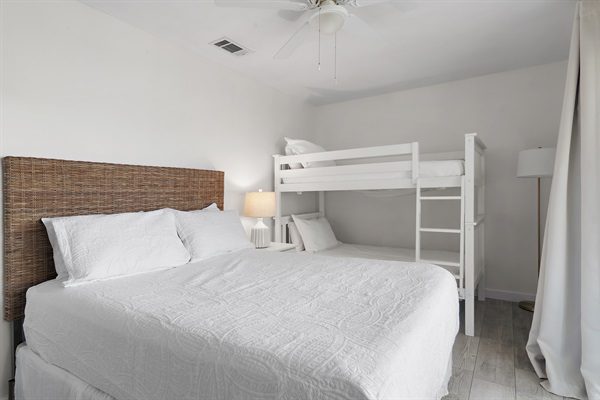 Charming Guest Bedroom: This room boasts a comfortable queen bed and a fun bunk bed setup, complete with a private balcony, making it perfect for families.