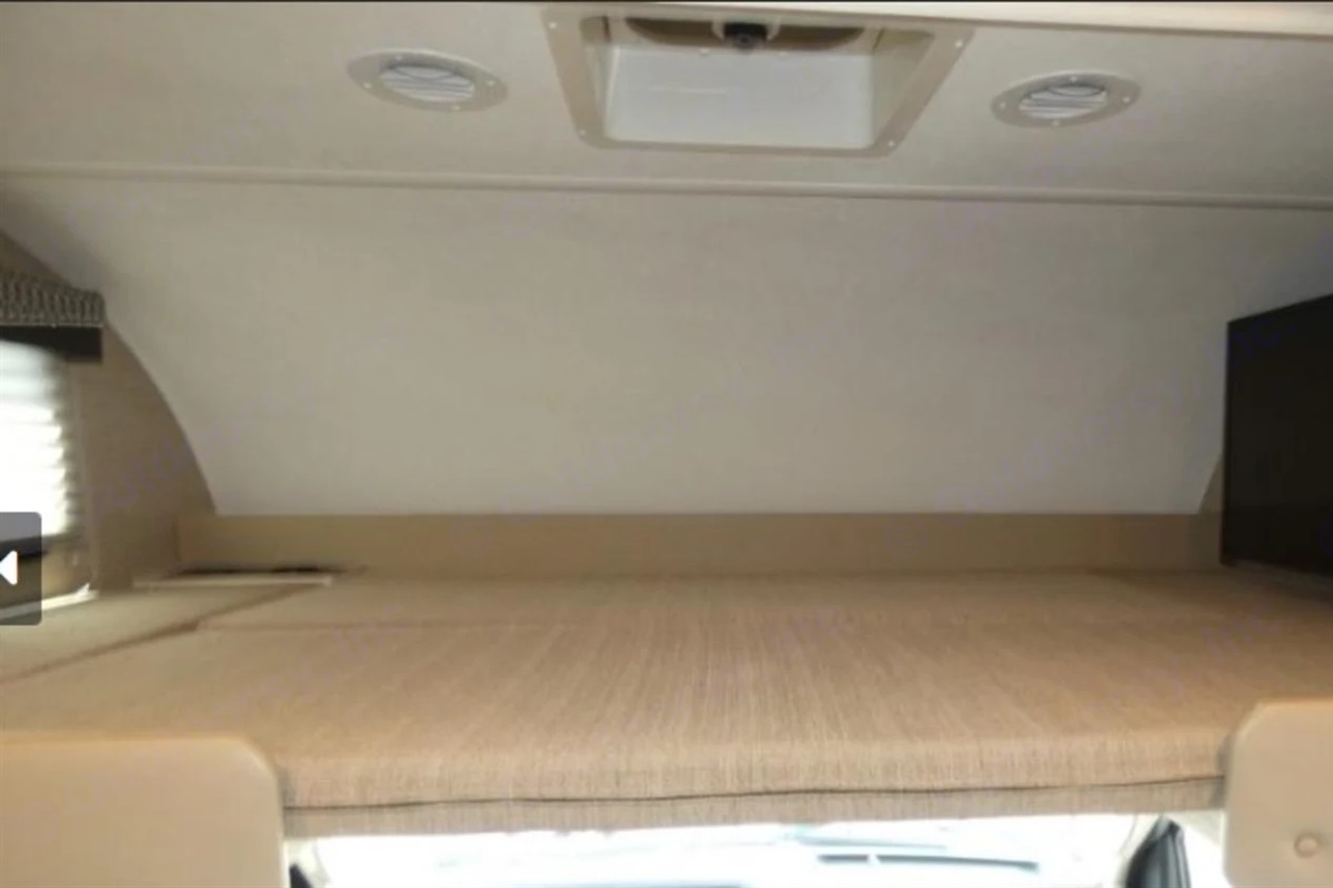 Ample room for sleeping above the cab, large TV