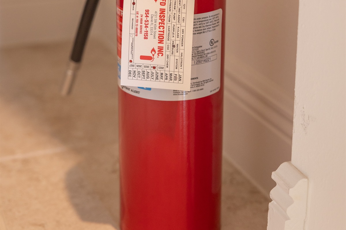 Fire extinguisher located under kitchen sink.