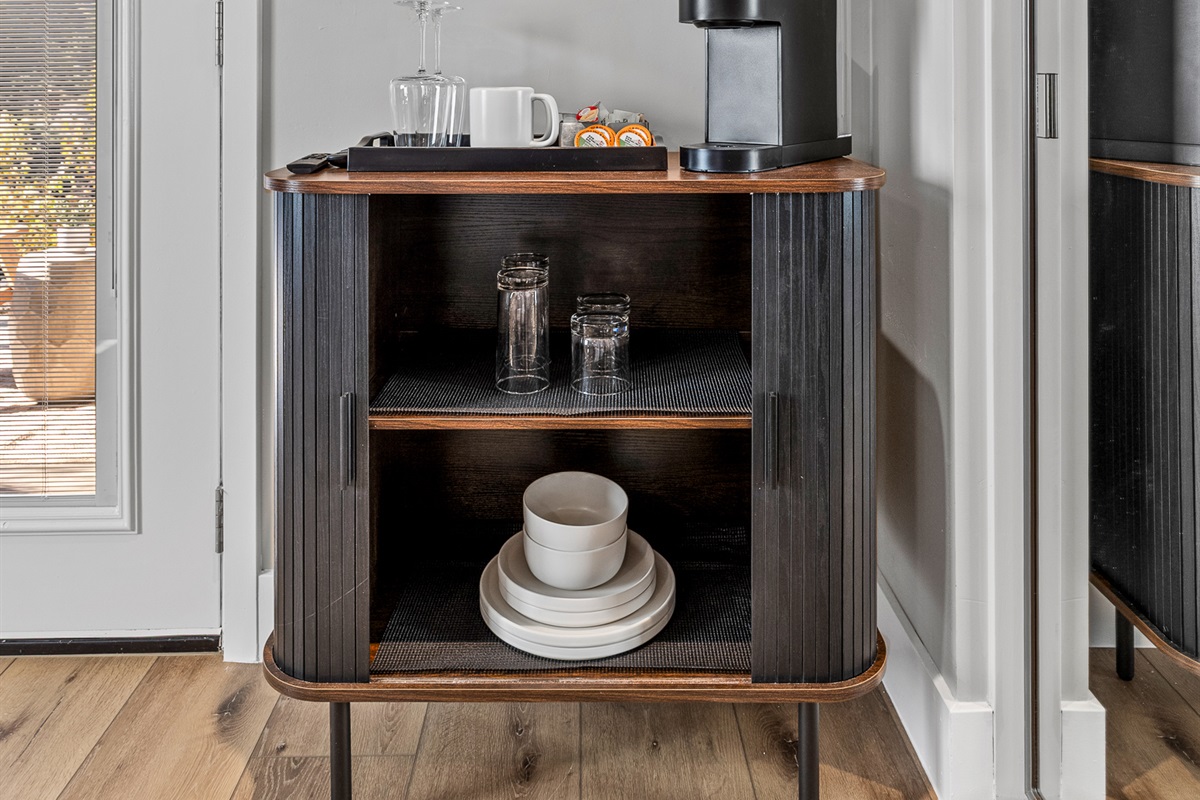 Thoughtfully designed coffee station with Keurig, dishware, and essentials for morning coffee or light snacks.