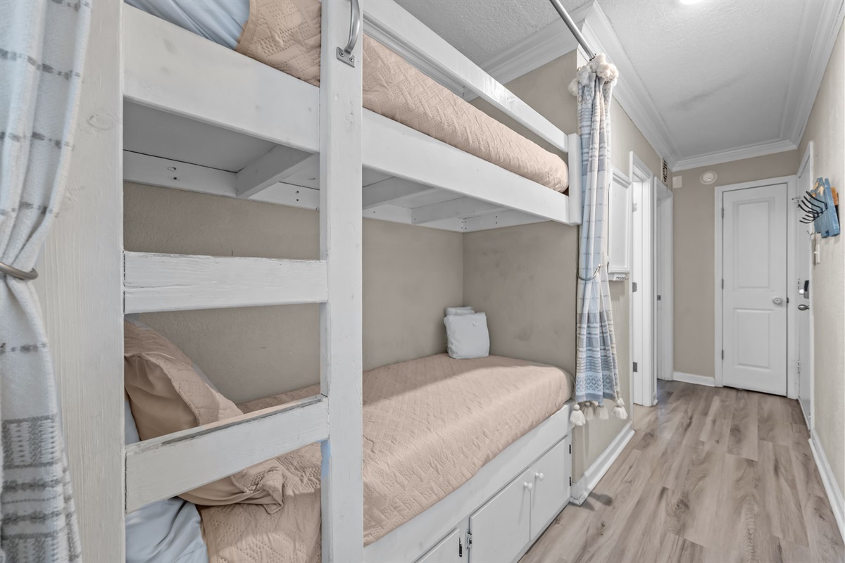 The cutest bunk beds equipped with privacy curtains, night lights and outlets. Cabinet storage below