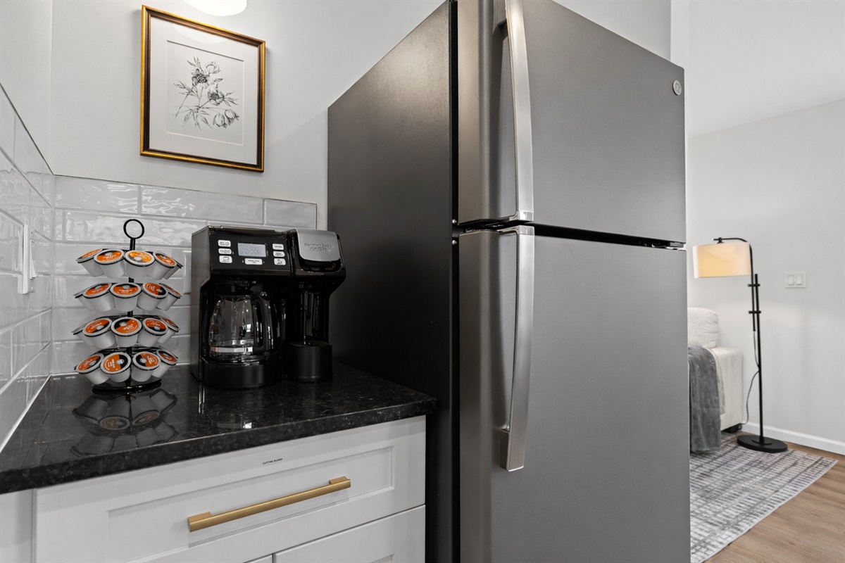Thoughtfully designed kitchen corner with full-size fridge and coffee station—everything you need for easy mornings and relaxed stays.