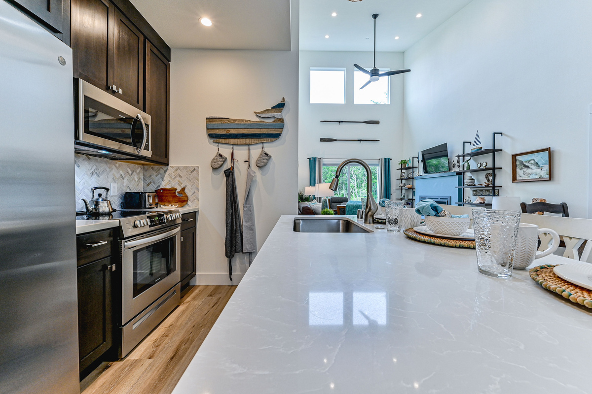 Cook shoulder-to-shoulder in a kitchen built for a crowd, with plenty of counter space and light woodwork throughout.