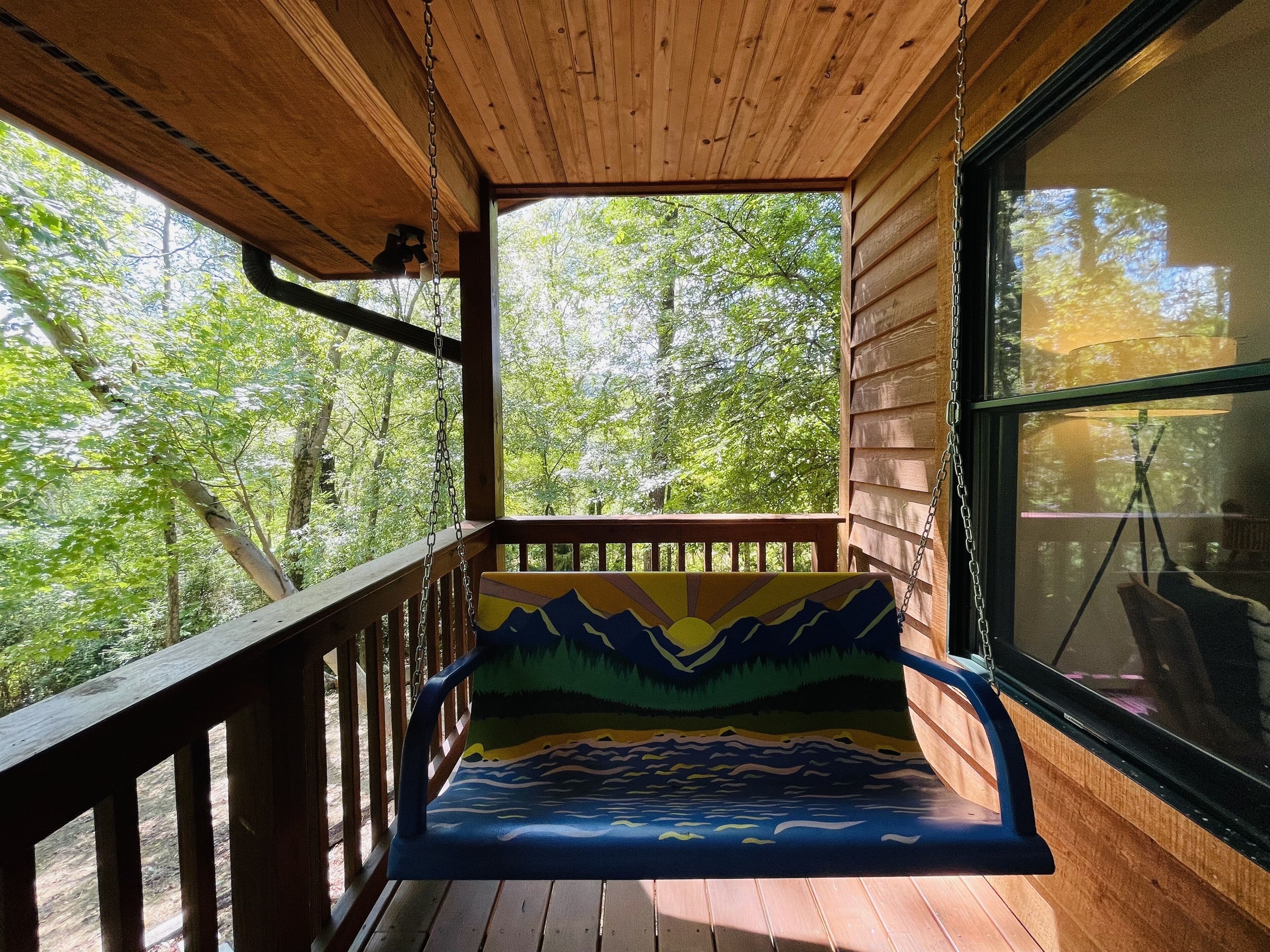 Hand painted front porch swing is a divine place to spend time
