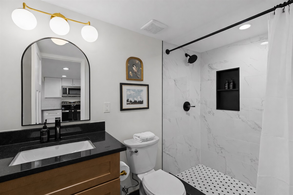 Modern, spa-inspired bathroom with a walk-in shower, sleek finishes, soft lighting, and fresh towels—clean, bright, and relaxing.