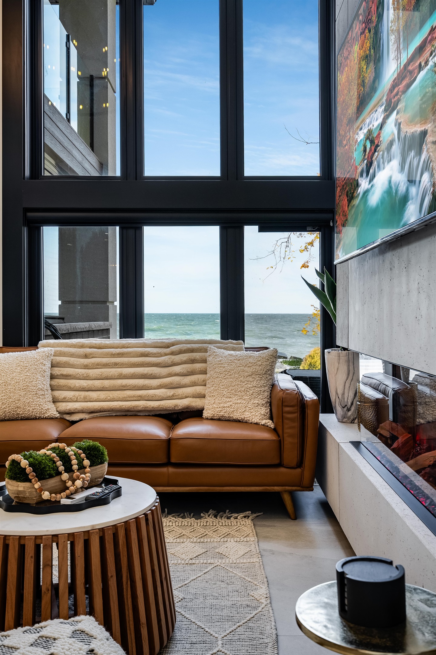 Orangish-brown accents in seating and cabinetry details create cohesion.