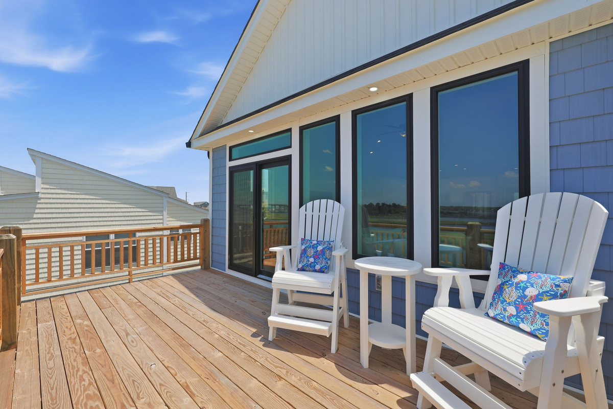 Relax on the spacious upper deck with comfortable Adirondack chairs while taking in sweeping views of the peaceful marsh and waterways