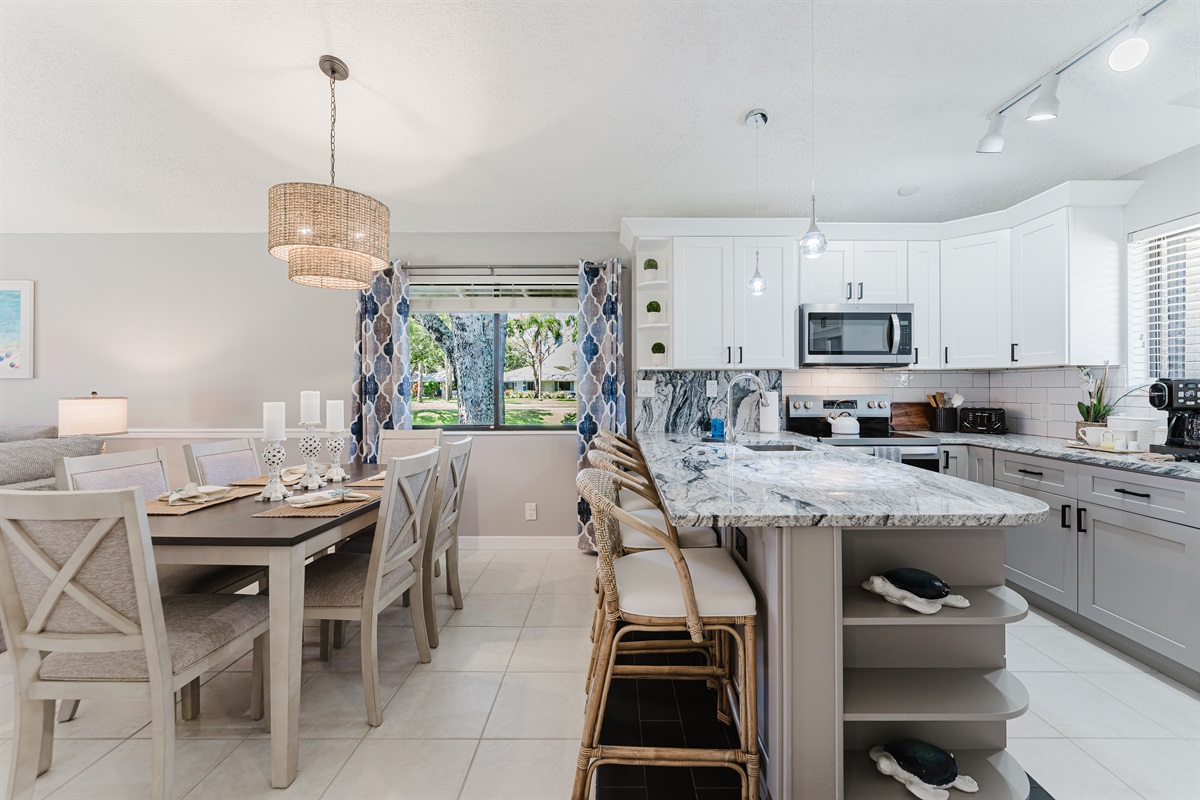 Bright open-concept living with dining for 6 and a fully upgraded kitchen featuring modern finishes, breakfast bar seating, and everything you need to cook and entertain

