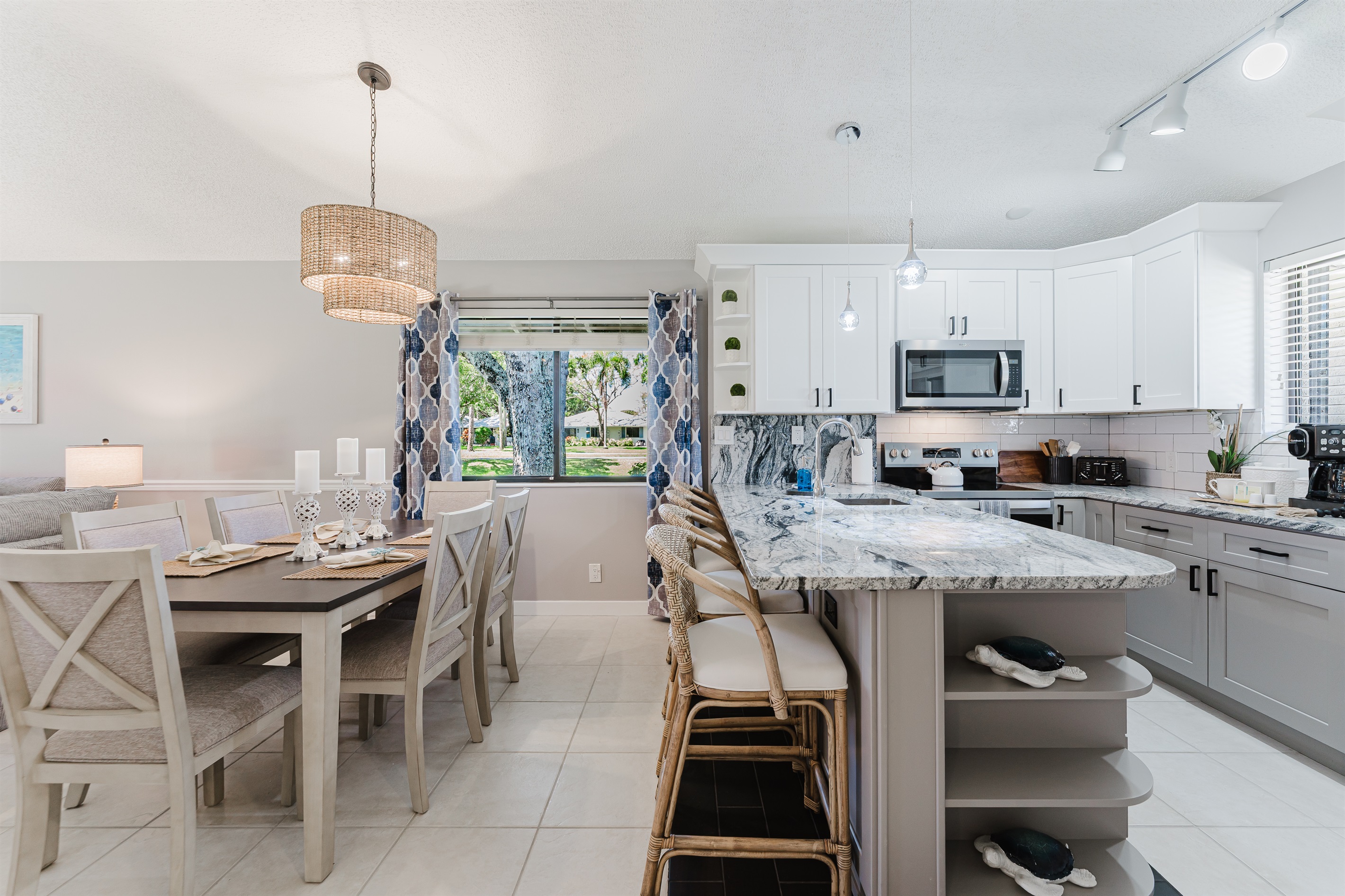 Bright open-concept living with dining for 6 and a fully upgraded kitchen featuring modern finishes, breakfast bar seating, and everything you need to cook and entertain
