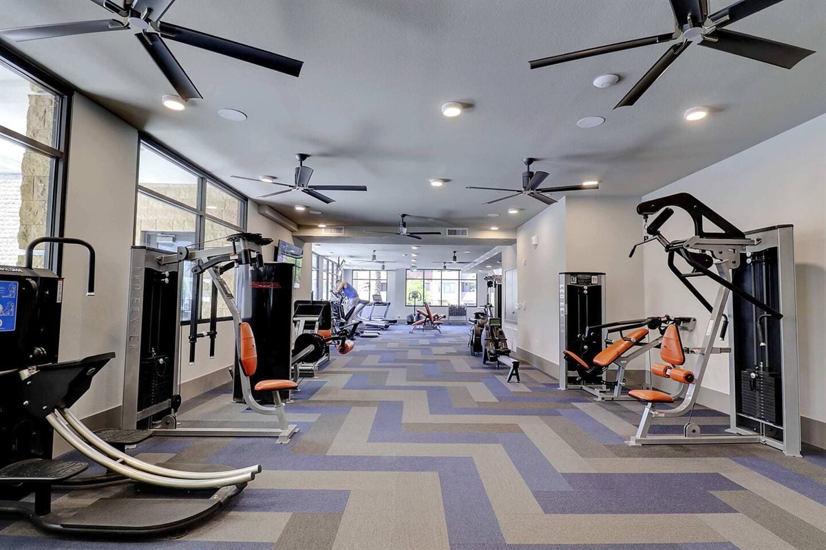 - Spacious fitness center with modern equipment and sleek flooring design   - Multiple cardio and strength machines for a complete workout routine   - Bright, open layout motivates guests to stay active and energized daily