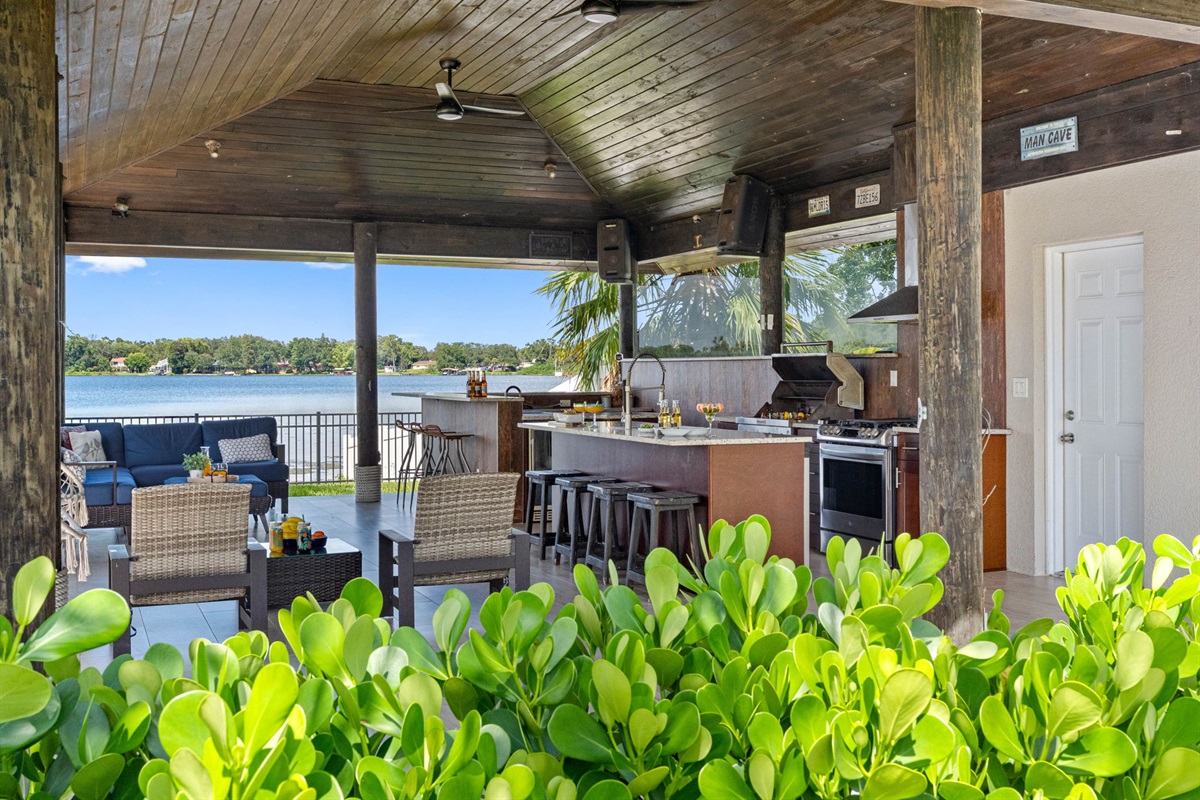 Host unforgettable gatherings with an outdoor kitchen, bar, cozy seating, and breathtaking scenery right by the water’s edge.